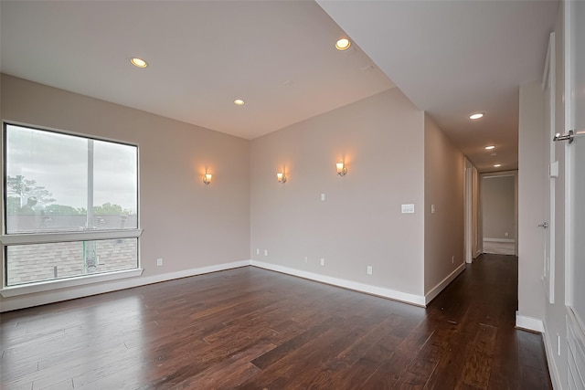 1305 Laird St, Houston, TX 77008 - empty room featuring dark wood finished floors, baseboards, and recessed lighting