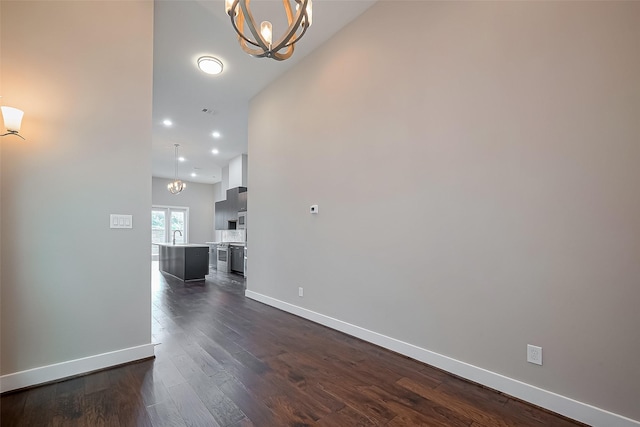 1305 Laird St, Houston, TX 77008 - unfurnished living room featuring a chandelier, baseboards, recessed lighting, dark wood-style flooring, and a sink