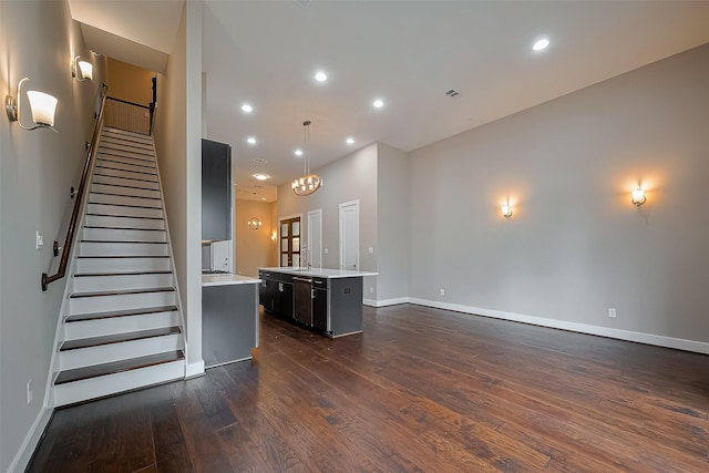 1305 Laird St, Houston, TX 77008 - unfurnished living room with dark wood-style flooring, baseboards, stairs, and recessed lighting