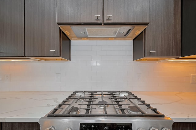 1305 Laird St, Houston, TX 77008 - kitchen with exhaust hood, backsplash, light stone counters, and stainless steel range with gas stovetop