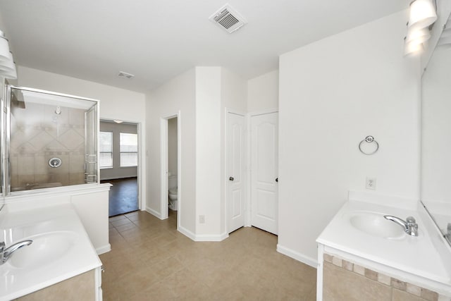bathroom with two vanities, visible vents, a sink, and a stall shower