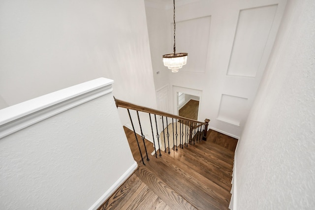 staircase with wood finished floors and baseboards