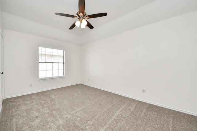 unfurnished room with baseboards, a ceiling fan, and carpet