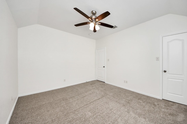 carpeted empty room with visible vents, baseboards, a ceiling fan, and lofted ceiling
