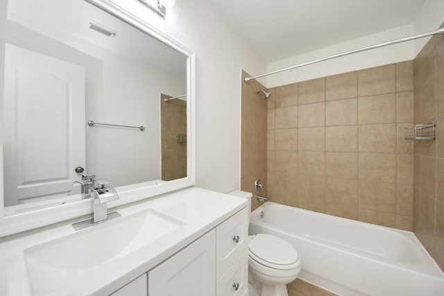 bathroom featuring visible vents, toilet, vanity, and washtub / shower combination