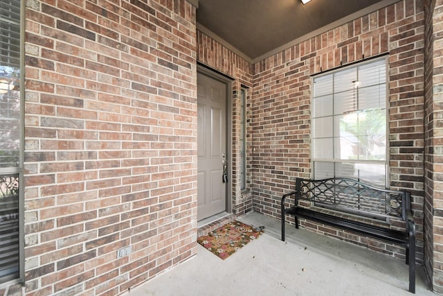property entrance with brick siding