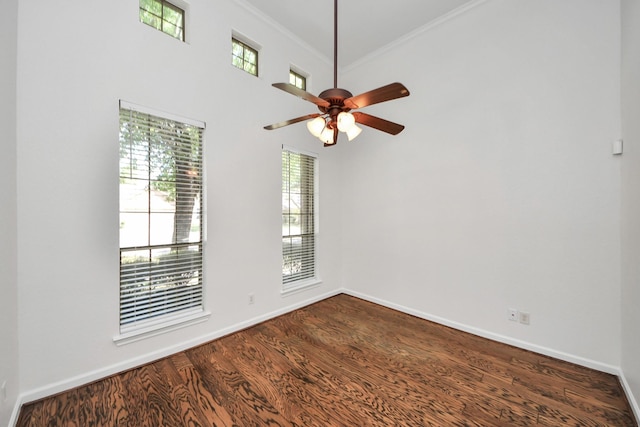 unfurnished room featuring a healthy amount of sunlight, baseboards, and dark wood finished floors