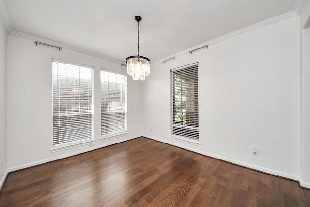 unfurnished dining area featuring dark wood-style flooring, a notable chandelier, ornamental molding, and baseboards
