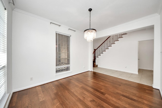 interior space with an inviting chandelier, stairway, crown molding, and wood finished floors