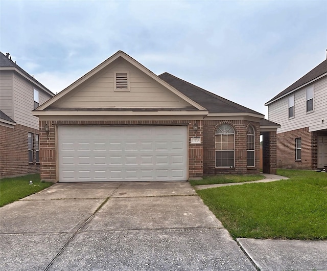 single story home featuring an attached garage, brick siding, driveway, and a front yard