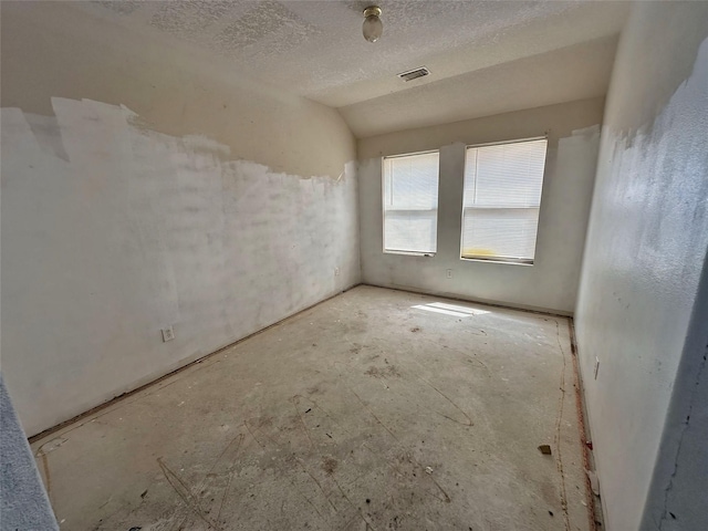 unfurnished room with a textured ceiling and visible vents