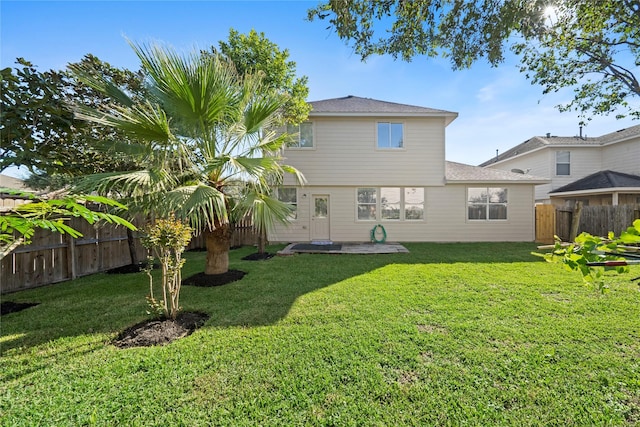 21355 Bella Mountain Dr, Spring, TX 77379 - back of property with a shingled roof, a yard, a fenced backyard, and a patio