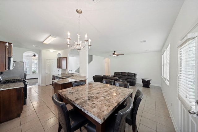 21355 Bella Mountain Dr, Spring, TX 77379 - dining space with a healthy amount of sunlight, arched walkways, light tile patterned flooring, and ceiling fan with notable chandelier