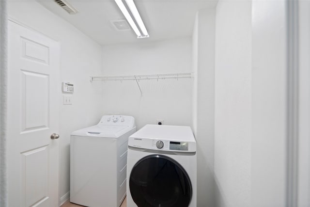 21355 Bella Mountain Dr, Spring, TX 77379 - clothes washing area with visible vents, laundry area, and washing machine and clothes dryer