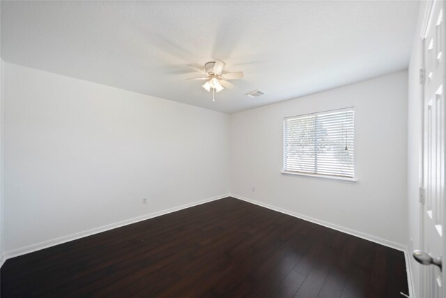 21355 Bella Mountain Dr, Spring, TX 77379 - empty room featuring dark wood-type flooring, visible vents, ceiling fan, and baseboards