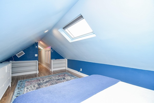 5902 Hummingbird St, Houston, TX 77096 - unfurnished bedroom featuring a skylight, wood finished floors, vaulted ceiling, and baseboards