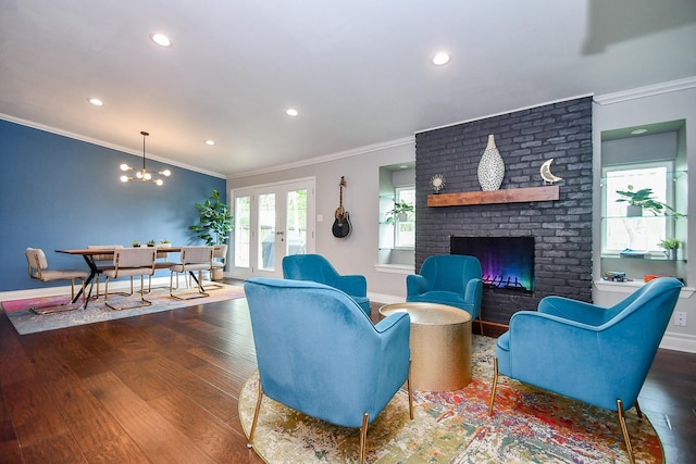 5902 Hummingbird St, Houston, TX 77096 - living room featuring crown molding, baseboards, wood finished floors, a chandelier, and french doors