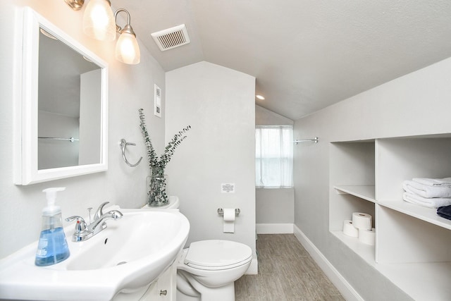 5902 Hummingbird St, Houston, TX 77096 - bathroom featuring vaulted ceiling, a sink, wood finished floors, toilet, and baseboards