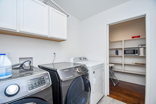 5902 Hummingbird St, Houston, TX 77096 - clothes washing area with cabinet space, washer and clothes dryer, and wood finished floors