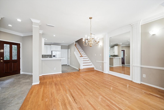 4422 Castle Court Pl, Houston, TX 77006 - foyer entrance featuring crown molding, stairway, recessed lighting, a chandelier, and light wood-style flooring