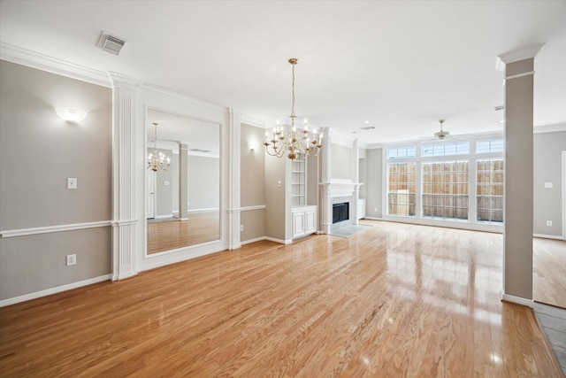 4422 Castle Court Pl, Houston, TX 77006 - unfurnished living room with a chandelier, a ceiling fan, light wood-style flooring, crown molding, and a fireplace with flush hearth