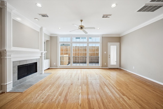 4422 Castle Court Pl, Houston, TX 77006 - unfurnished living room featuring a ceiling fan, a tile fireplace, ornamental molding, light wood-type flooring, and recessed lighting
