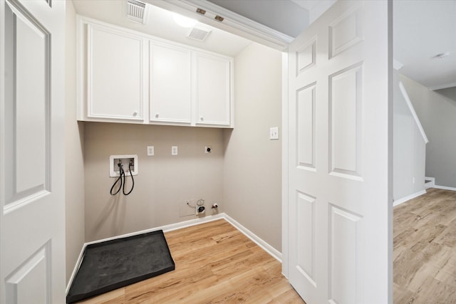 4422 Castle Court Pl, Houston, TX 77006 - laundry area with cabinet space, hookup for a gas dryer, hookup for a washing machine, light wood-style flooring, and electric dryer hookup