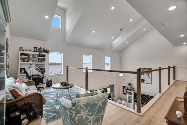 interior space featuring recessed lighting, high vaulted ceiling, and wood finished floors
