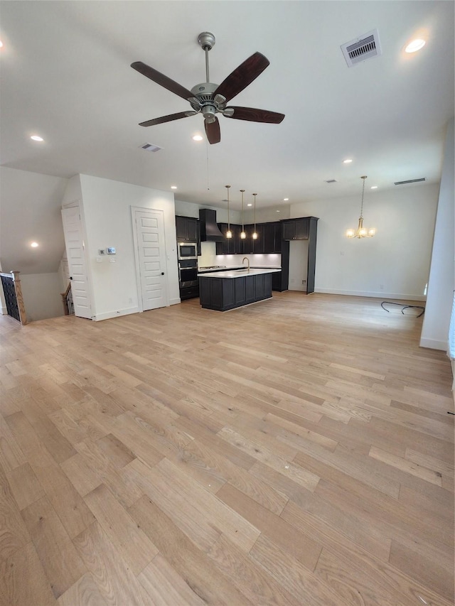 409 Forest Reserve Pl, Houston, TX 77079 - unfurnished living room with a ceiling fan, light wood-style flooring, baseboards, a sink, and recessed lighting