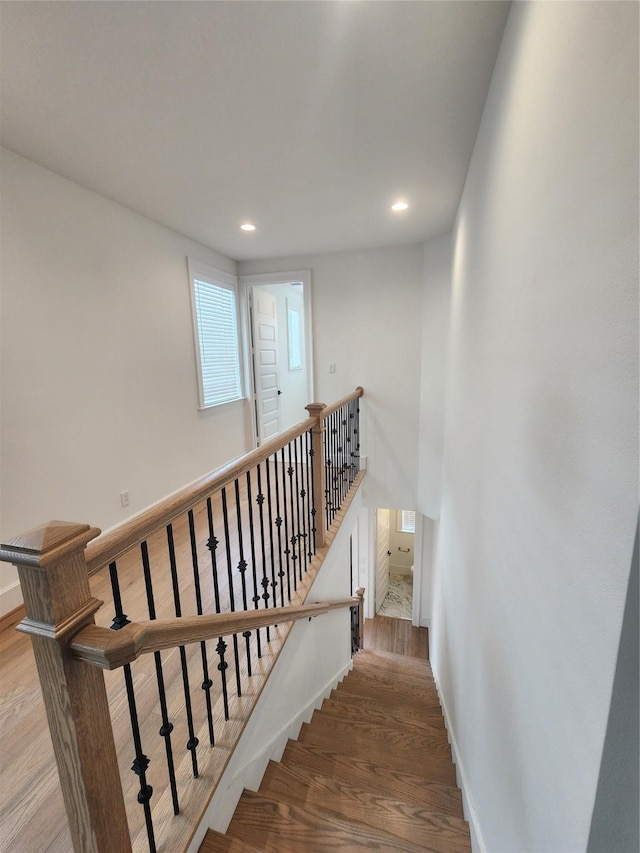 409 Forest Reserve Pl, Houston, TX 77079 - staircase featuring wood finished floors, baseboards, and recessed lighting