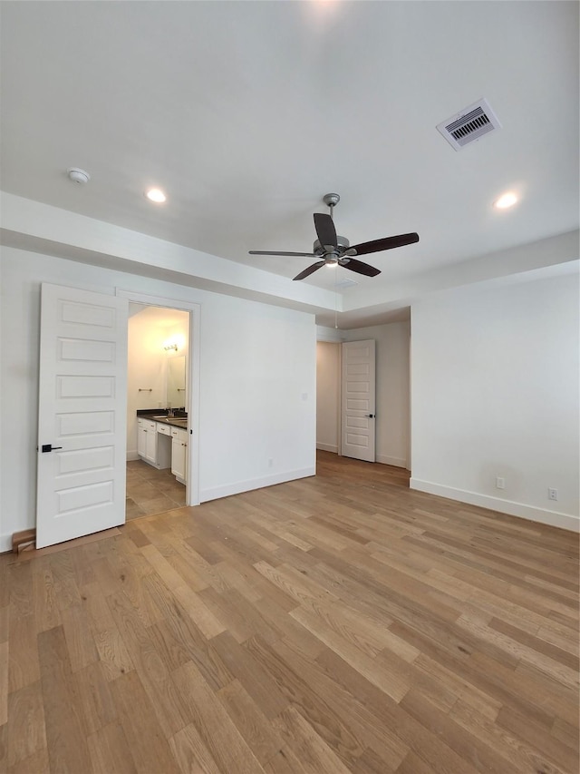409 Forest Reserve Pl, Houston, TX 77079 - unfurnished bedroom featuring light wood-type flooring, baseboards, recessed lighting, a desk, and ensuite bath