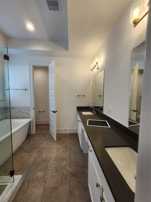 409 Forest Reserve Pl, Houston, TX 77079 - bathroom with a freestanding bath, double vanity, baseboards, and stone finish floors