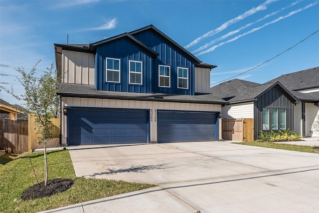 8132 Brandon St, Houston, TX 77051 - view of front of house with board and batten siding, driveway, fence, and a garage