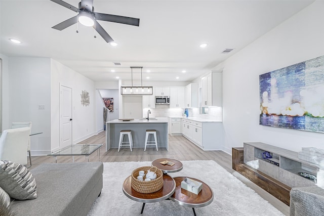 8132 Brandon St, Houston, TX 77051 - living area with light wood-style flooring, ceiling fan, visible vents, and recessed lighting
