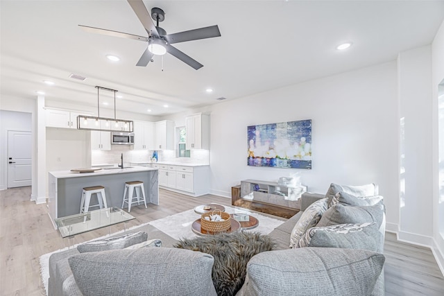 8132 Brandon St, Houston, TX 77051 - living area with visible vents, ceiling fan, light wood-style floors, and baseboards