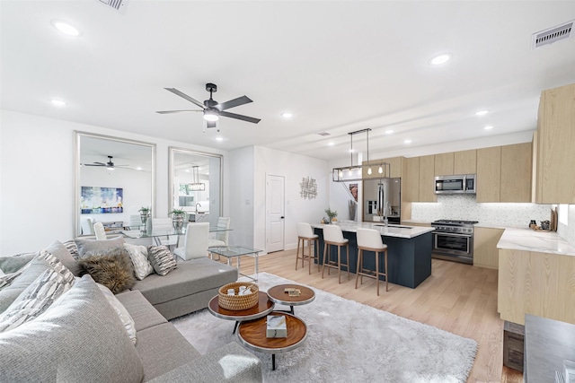 8132 Brandon St, Houston, TX 77051 - living area featuring visible vents, a ceiling fan, recessed lighting, and light wood finished floors