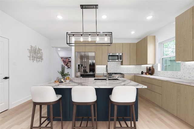 8132 Brandon St, Houston, TX 77051 - kitchen with modern cabinets, light brown cabinetry, and appliances with stainless steel finishes