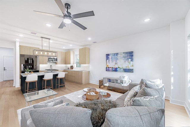 8132 Brandon St, Houston, TX 77051 - living room featuring light wood-type flooring, ceiling fan, visible vents, and recessed lighting