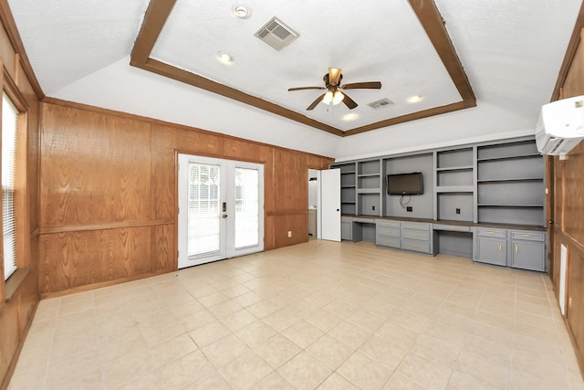 1802 Warwickshire Dr, Houston, TX 77077 - unfurnished living room with a ceiling fan, a raised ceiling, wooden walls, a wall mounted AC, and light tile patterned floors