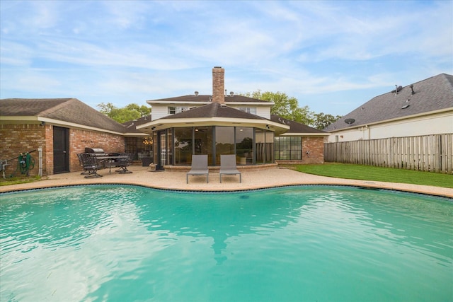 view of pool with a patio, a fenced in pool, and fence