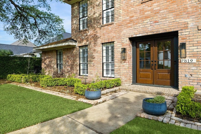 doorway to property with french doors and brick siding