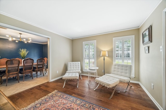 sitting room featuring ornamental molding, wood finished floors, and a healthy amount of sunlight