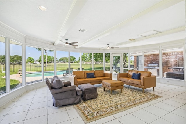 sunroom featuring visible vents, beam ceiling, and a healthy amount of sunlight