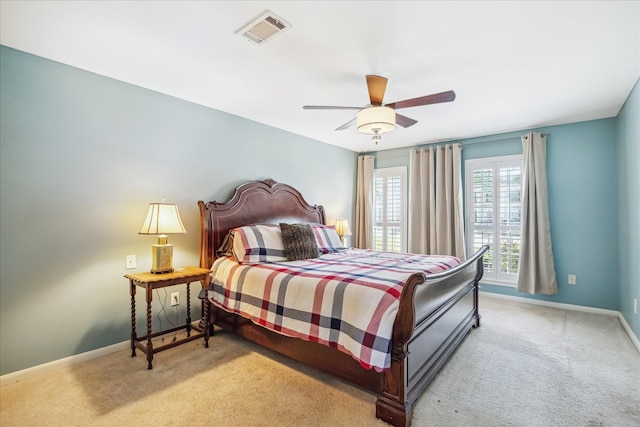carpeted bedroom featuring visible vents, baseboards, and ceiling fan