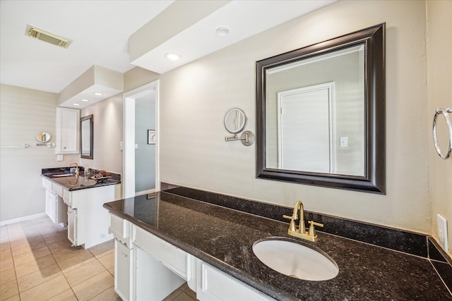 bathroom featuring tile patterned floors, baseboards, visible vents, and vanity