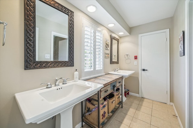 bathroom featuring tile patterned floors, baseboards, a sink, and recessed lighting