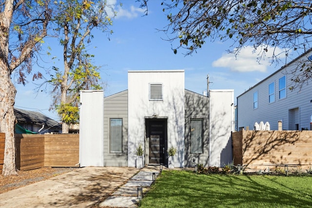 view of front of house with a front yard and fence