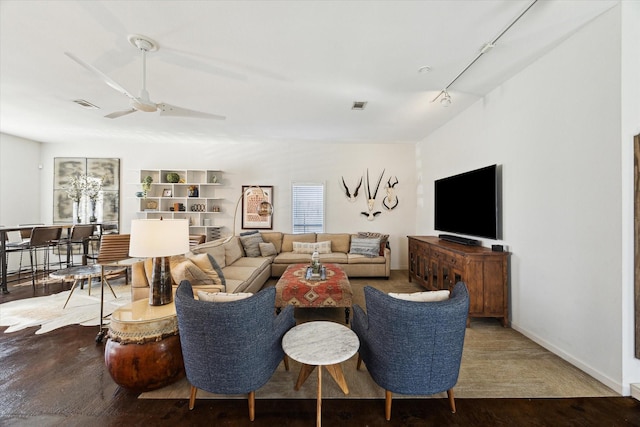 living area with visible vents, a ceiling fan, wood finished floors, and track lighting