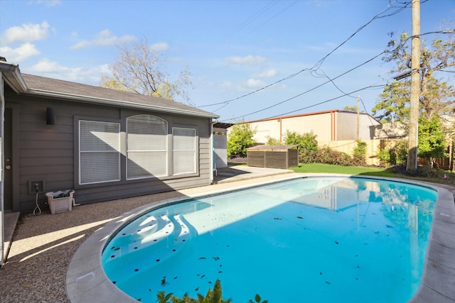 view of pool with a patio area, a fenced in pool, and fence