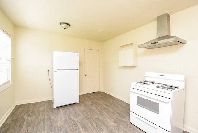 kitchen featuring wall chimney range hood, white appliances, light wood-style floors, and baseboards